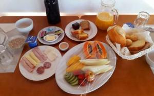 a wooden table with plates of food on it at BEACH HOUSE l in Itacaré +34 photos