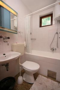 a white bathroom with a toilet and a sink at Apartments with a parking space Podaca, Makarska - 6798 in Podaca