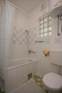 a bathroom with a tub and a toilet and a sink at Apartments with a parking space Podaca, Makarska - 6798 in Podaca