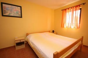 ein Schlafzimmer mit einem weißen Bett und einem Fenster in der Unterkunft Apartment Mandre 6456b in Mandre
