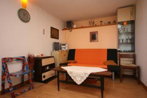 a room with a table and a desk and a kitchen at Apartments with a parking space Podgora, Makarska - 6645 in Podgora