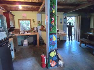 a room with a person standing in the doorway at Hostel Del Lago Yojoa Backpackers in Agua Azul