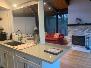 a kitchen with a sink and a living room with a fireplace at Rustridge Ranch & Winery in St. Helena