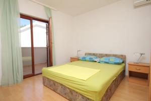 a bedroom with a bed and a large window at Apartments by the sea Baska Voda, Makarska - 6848 in Baška Voda