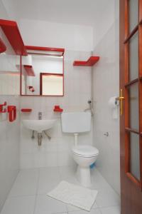 a bathroom with a toilet and a sink at Apartments by the sea Baska Voda, Makarska - 6848 in Baška Voda