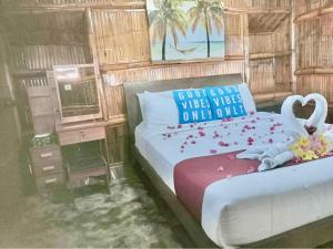 a bedroom with a bed with roses on it at GEM Crystal Water Resort in Davao City