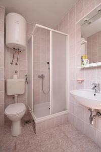 a bathroom with a shower and a toilet and a sink at Studio Podaca 6902c in Podaca