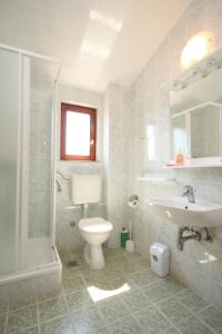 a bathroom with a sink and a toilet and a shower at Apartments by the sea Podaca, Makarska - 6902 in Podaca