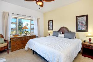 a bedroom with a large bed and a window at Menehune Shores 626 in Kihei