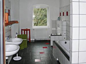 a bathroom with two sinks and a tub and a window at Elegance in Rotschönberg in Großschirma +31 photos