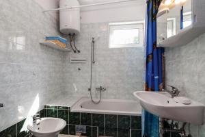a bathroom with a sink and a tub and a toilet at Apartments with a parking space Pag - 6461 in Pag +22 photos