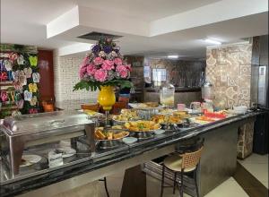 a buffet with many plates of food on a counter at Flat beira mar Tambaú in João Pessoa