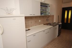 a kitchen with white cabinets and a sink at Apartments and rooms by the sea Starigrad, Paklenica - 6588 in Starigrad