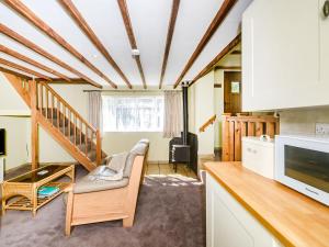 ein Wohnzimmer mit Sofa und Fernseher in der Unterkunft Creenagh's Cottage in Withypool + 23 Fotos