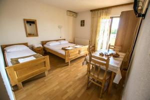 a small room with two beds and a table and a table sidx sidx at Apartments with a parking space Starigrad, Paklenica - 6595 in Starigrad-Paklenica