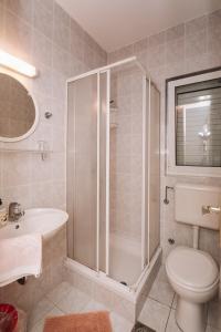 a bathroom with a shower and a toilet and a sink at Apartments and rooms with parking space Novalja, Pag - 6482 in Novalja +46 photos