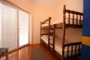 a bedroom with two bunk beds and a window at Holiday house with a parking space Novalja, Pag - 6492 in Novalja