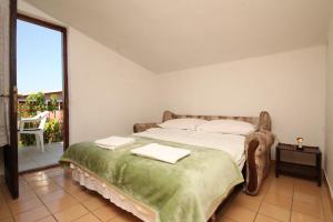 a bedroom with a bed with two towels on it at Apartments with a parking space Starigrad, Paklenica - 6647 in Starigrad-Paklenica