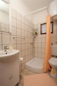a bathroom with a sink and a toilet and a shower at Apartment Starigrad 6647a in Starigrad
