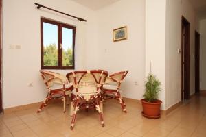 a dining room with two chairs and a table at Apartment Starigrad 6647a in Starigrad