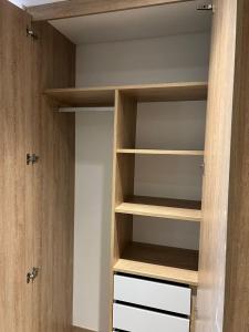 a walk in closet with wooden shelves at Espectacular apartamento en Chapinero in Bogotá