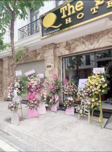 a bunch of flowers sitting outside of a store at Hotel The Quin in Hai Phong