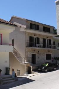 a black car parked in front of a building at Apartments and rooms with parking space Podgora, Makarska - 6790 in Podgora