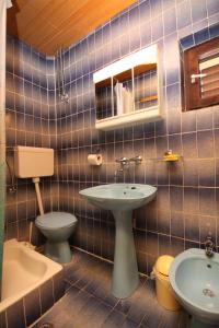 a bathroom with a sink and a toilet at Apartments and rooms with parking space Podgora, Makarska - 6790 in Podgora