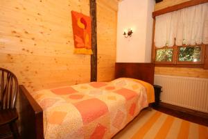 a bedroom with a bed in a wooden room at Family friendly house with a swimming pool Breze, Novi Vinodolski - 6920 in Ledenice