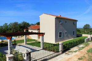 a villa with a pool and a house at Family friendly house with a swimming pool Valtura, Pula - 6913 in Ližnjan