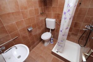 a bathroom with a toilet and a sink and a shower at Apartments with a parking space Pag - 6529 in Pag