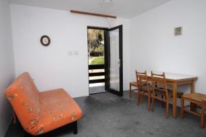 a dining room with an orange chair and a table at Apartments with a parking space Pag - 6529 in Pag