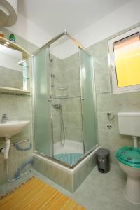 a bathroom with a shower and a toilet and a sink at Apartments by the sea Pasman - 8295 in Pašman