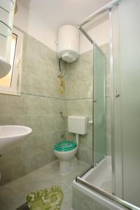 a bathroom with a toilet and a sink and a shower at Apartments by the sea Pasman - 8295 in Pašman +13 photos