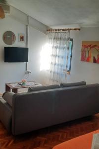 a large couch in a living room with a table at Studio Kali 8202a in Kali