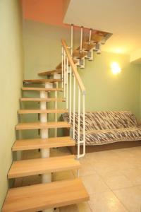 a staircase in a room with a bed at Holiday house Lastovo - 8289 in Lastovo