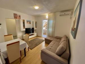a living room with a couch and a table at Apartment Zaklopatica 8342b in Lastovo