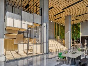 a rendering of a lobby with a table and chairs at Artyzen Habitat Lingang Shanghai in Shanghai