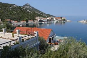 a view of a body of water with houses at Apartments by the sea Zaklopatica, Lastovo - 8346 in Lastovo