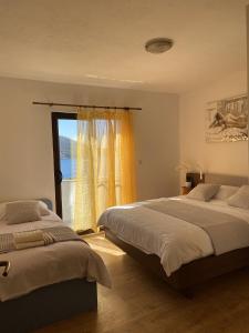 a bedroom with two beds and a window at Apartments by the sea Ubli, Lastovo - 8344 in Ubli