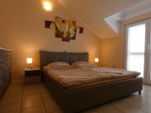 a bedroom with a bed and a window and two lamps at Apartments by the sea Ubli, Lastovo - 8354 in Ubli