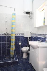 a bathroom with a toilet and a sink at Apartments by the sea Ubli, Lastovo - 8355 in Ubli