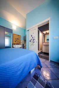 a bedroom with a blue bed and a bathroom at Studio Brbinj 8160a in Brbinj
