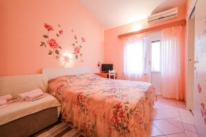 a bedroom with two beds and a window at Apartments with a parking space Brbinj, Dugi otok - 8160 in Brbinj