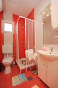 a bathroom with a shower and a toilet and a sink at Apartments by the sea Pasman - 8217 in Pašman