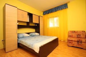 a bedroom with a bed and yellow walls at Seaside holiday house Kali, Ugljan - 8429 in Kali