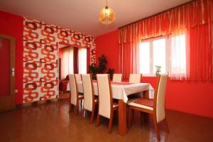 a dining room with red walls and a table and chairs at Seaside holiday house Kali, Ugljan - 8429 in Kali