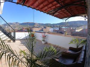 a balcony with chairs and a view of a city at Hospedaje Bellido in Ayacucho
