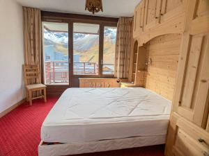 a bedroom with a large bed in front of a window at Appartement Tignes, 3 pièces, 8 personnes - FR-1-502-363 in Tignes