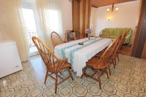 a dining room with a table and chairs at Apartments by the sea Kastel Stafilic, Kastela - 8621 in Kaštela